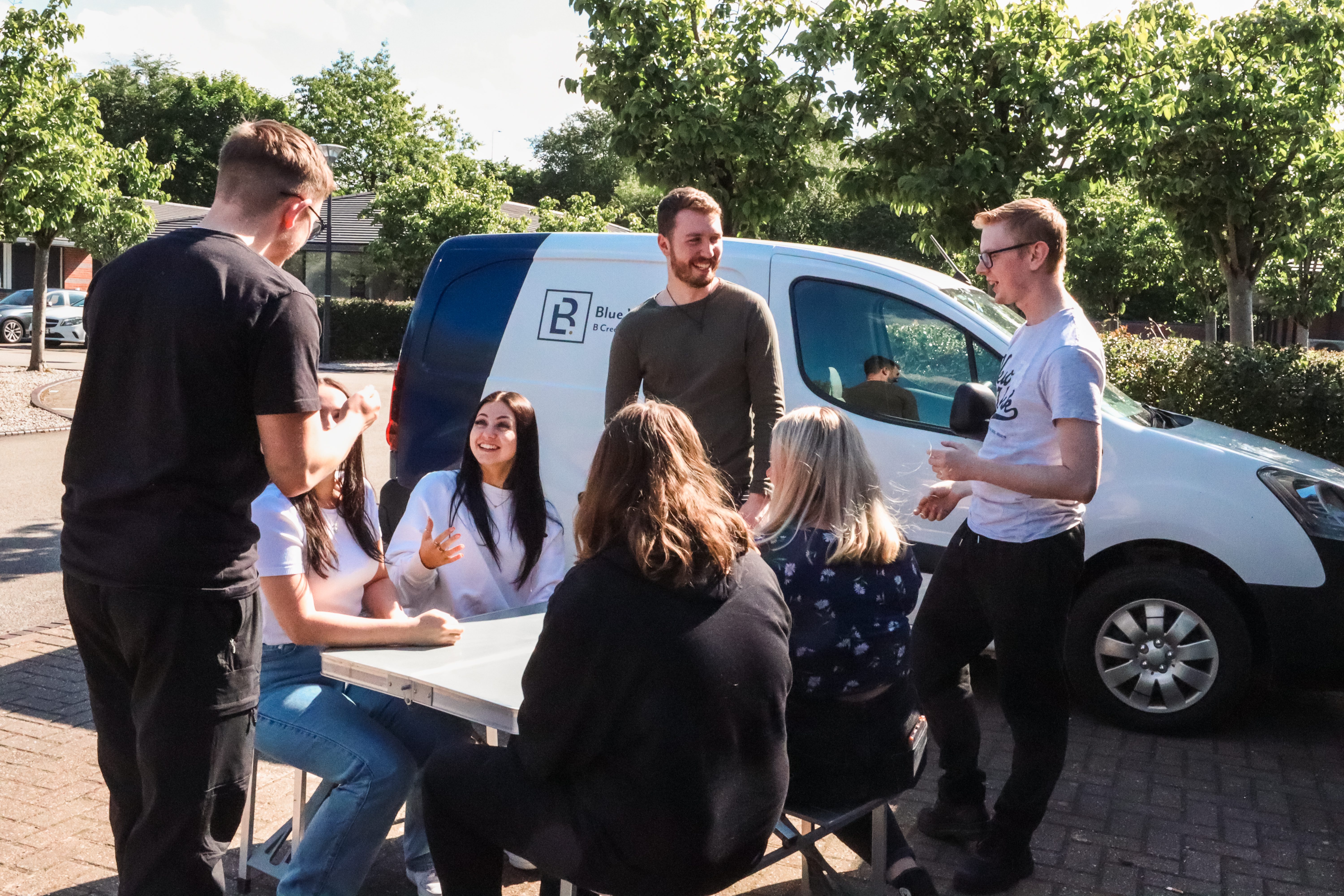 Blue Whale Media team sat at a table outside